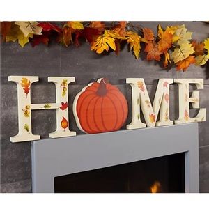 Temp-tations , Wooden Letters that spell HOME, with pumpkin as letter O.